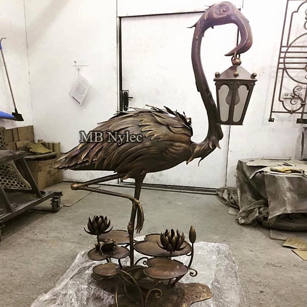 metal forged lamp with a bird