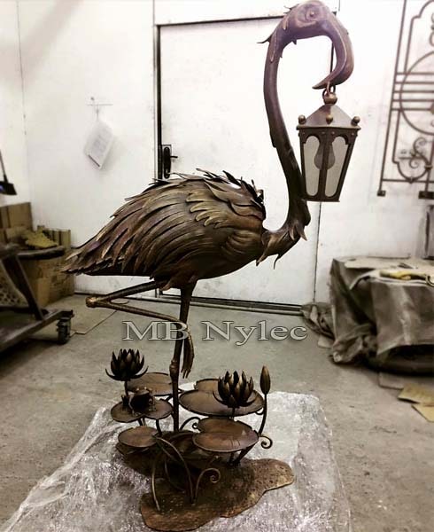 Designer lamp with a bird sculpture