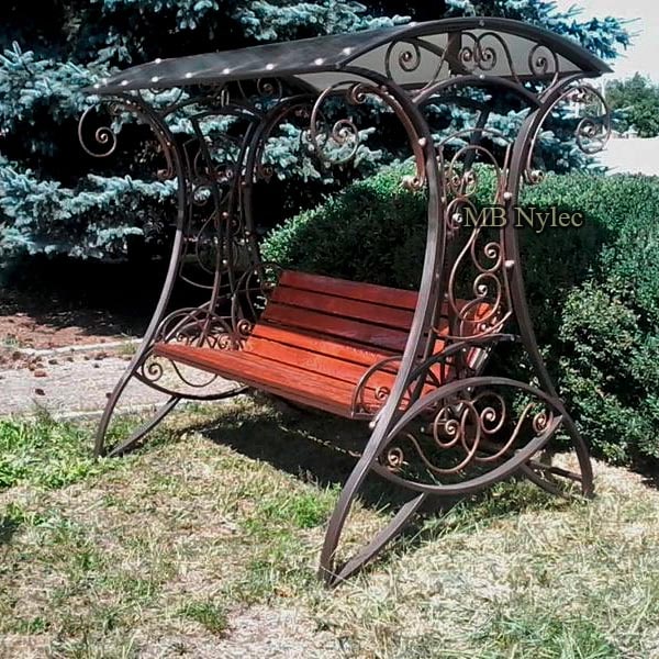 Steel garden swing with curved forged legs, scroll side balustrades, wooden seat and polycarbonate roof