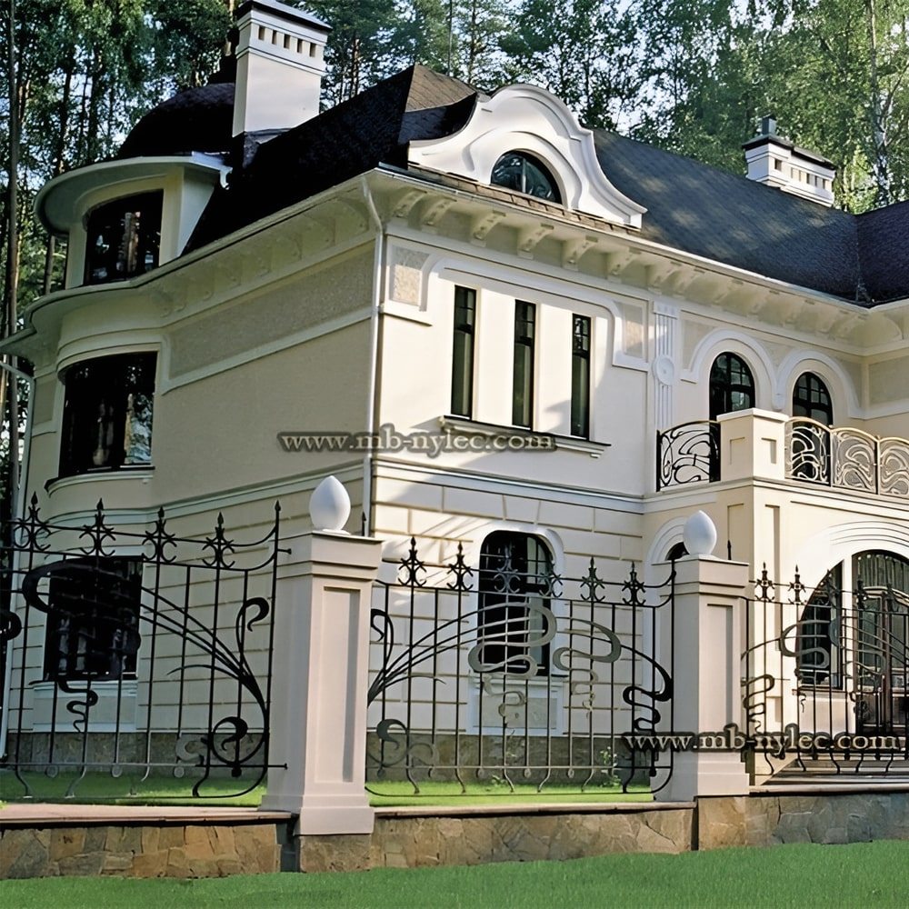 Art Nouveau forged fence BP45 with gently arched spans around a large white villa