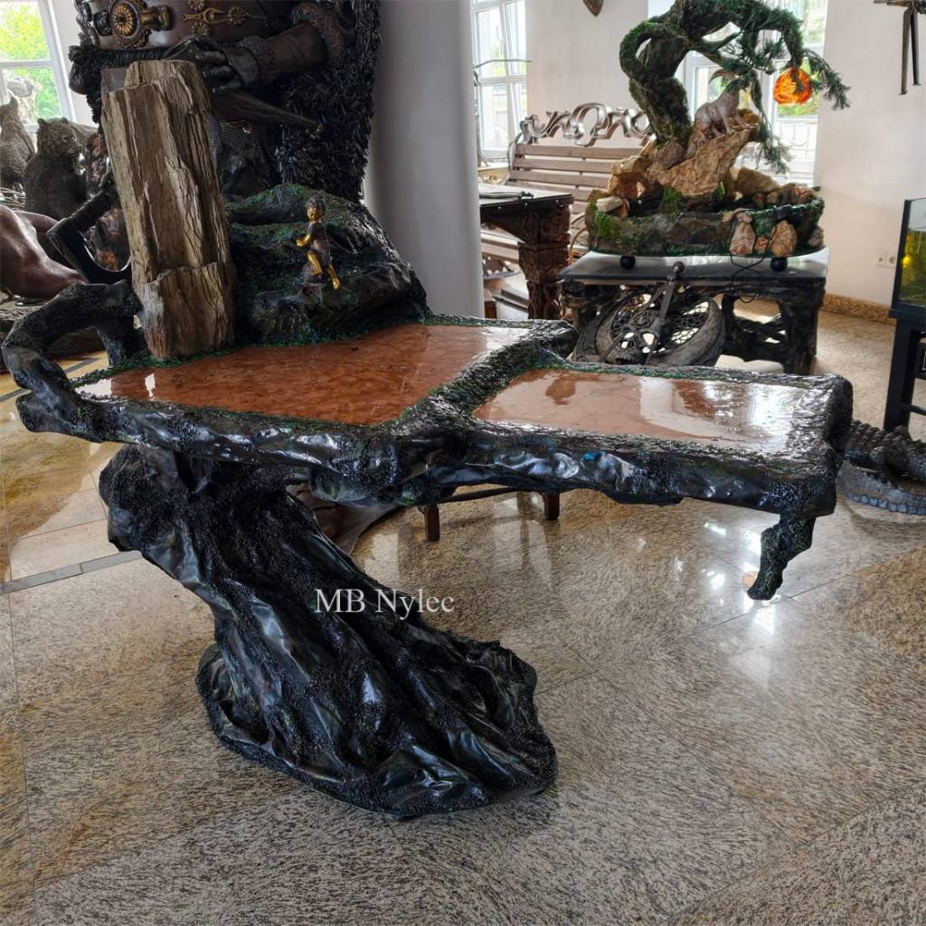 Artistic coffee table of forged steel with a marble top and petrified wood