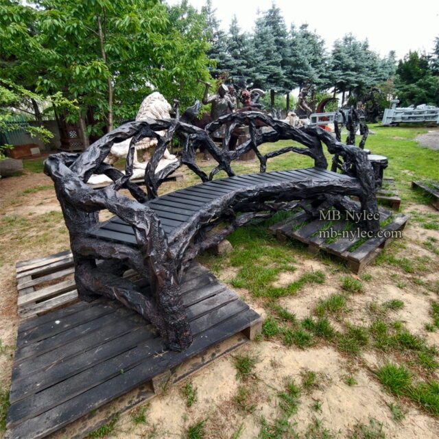 Artistic curved metal bench in the workshop garden