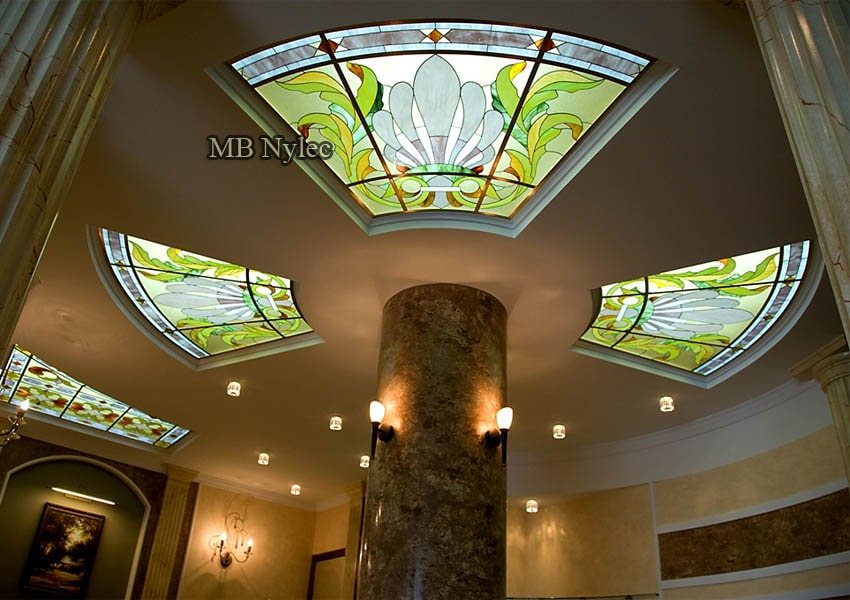 Backlit stained glass ceiling panels around a marble column in a residence