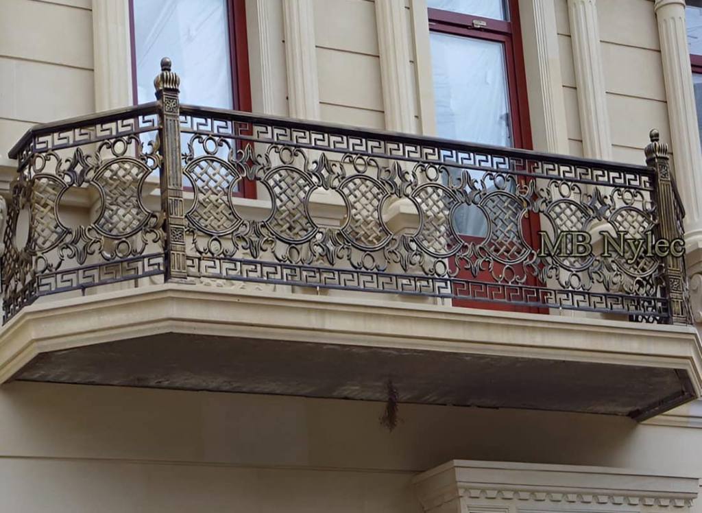 Elegant balcony railing BA35 with a Greek key band, circles and lattice on a classical facade