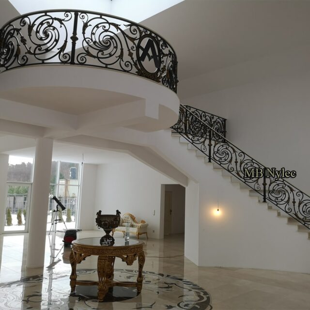Baroque-style gallery railing above a staircase