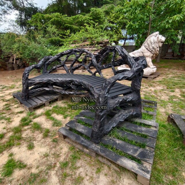 Curved designer bench of tangled forged branches in a garden