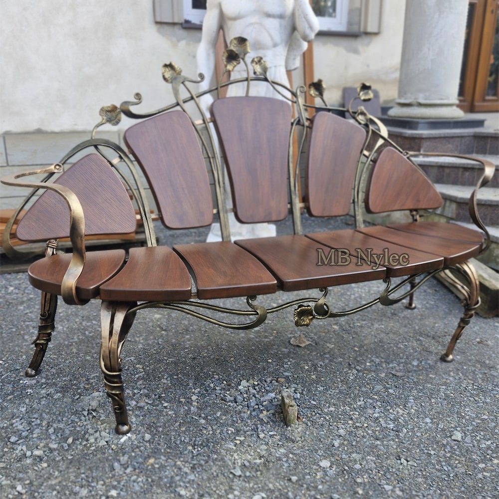 Angled view of bench MK17 showing its curved forged armrest