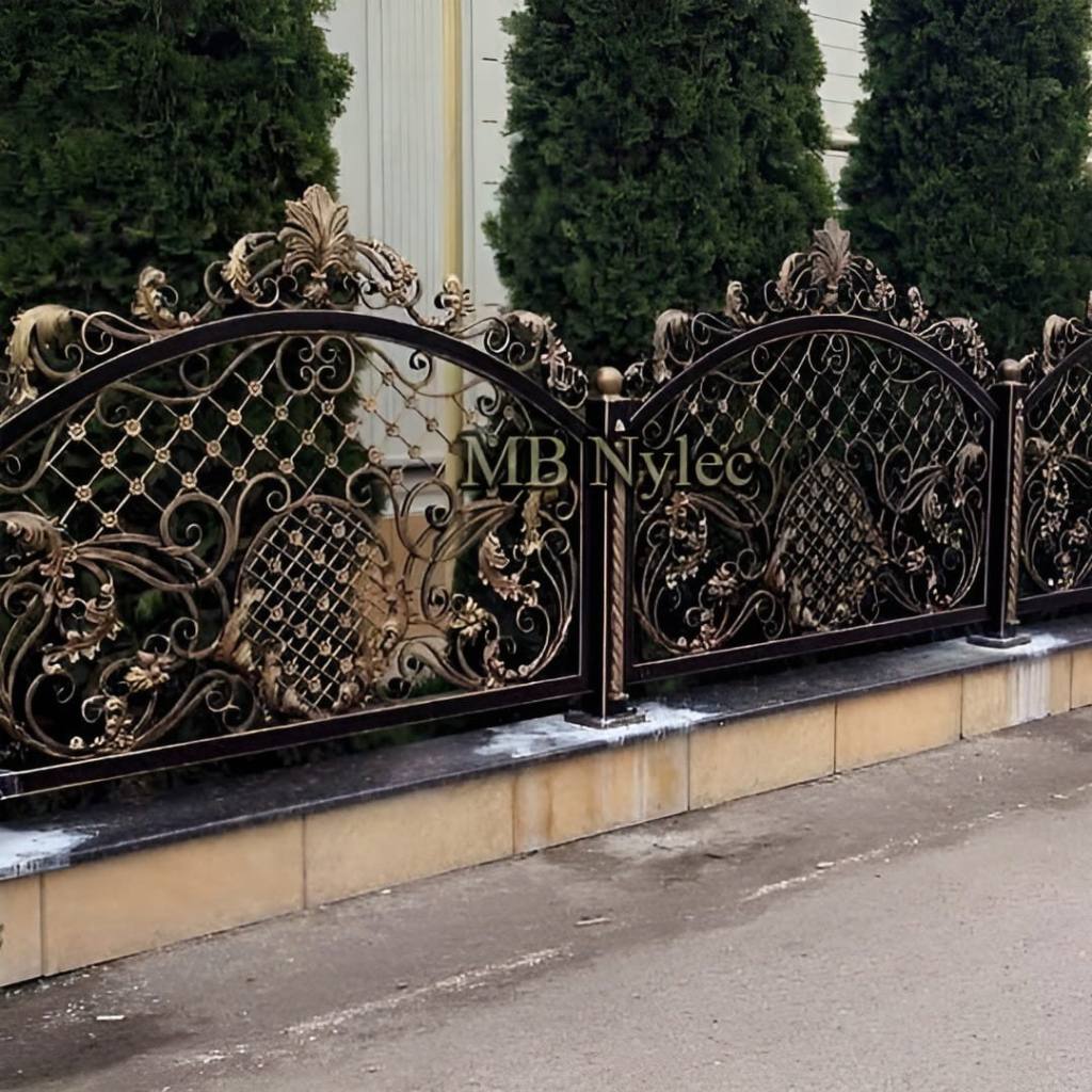 Heavily decorated fence BP250 with lattice and gold crests along a pavement
