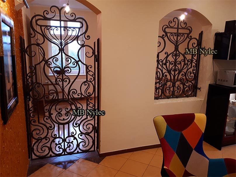 Door grille DZ4 beside a matching forged window grille in a living room