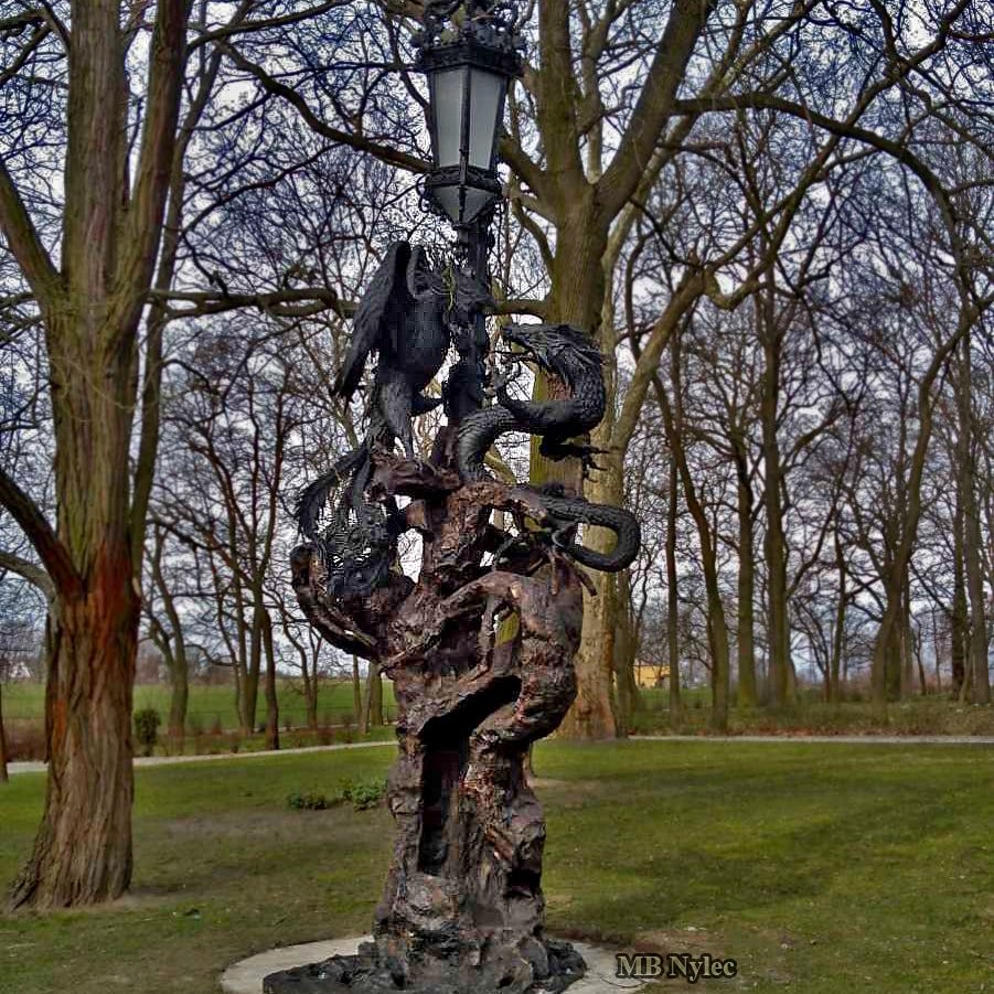 Seven-metre forged lamp OGD122 with a dragon and phoenix on an old tree in a park