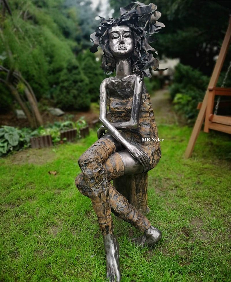 Elegant Lady steel sculpture with crossed legs on a stump