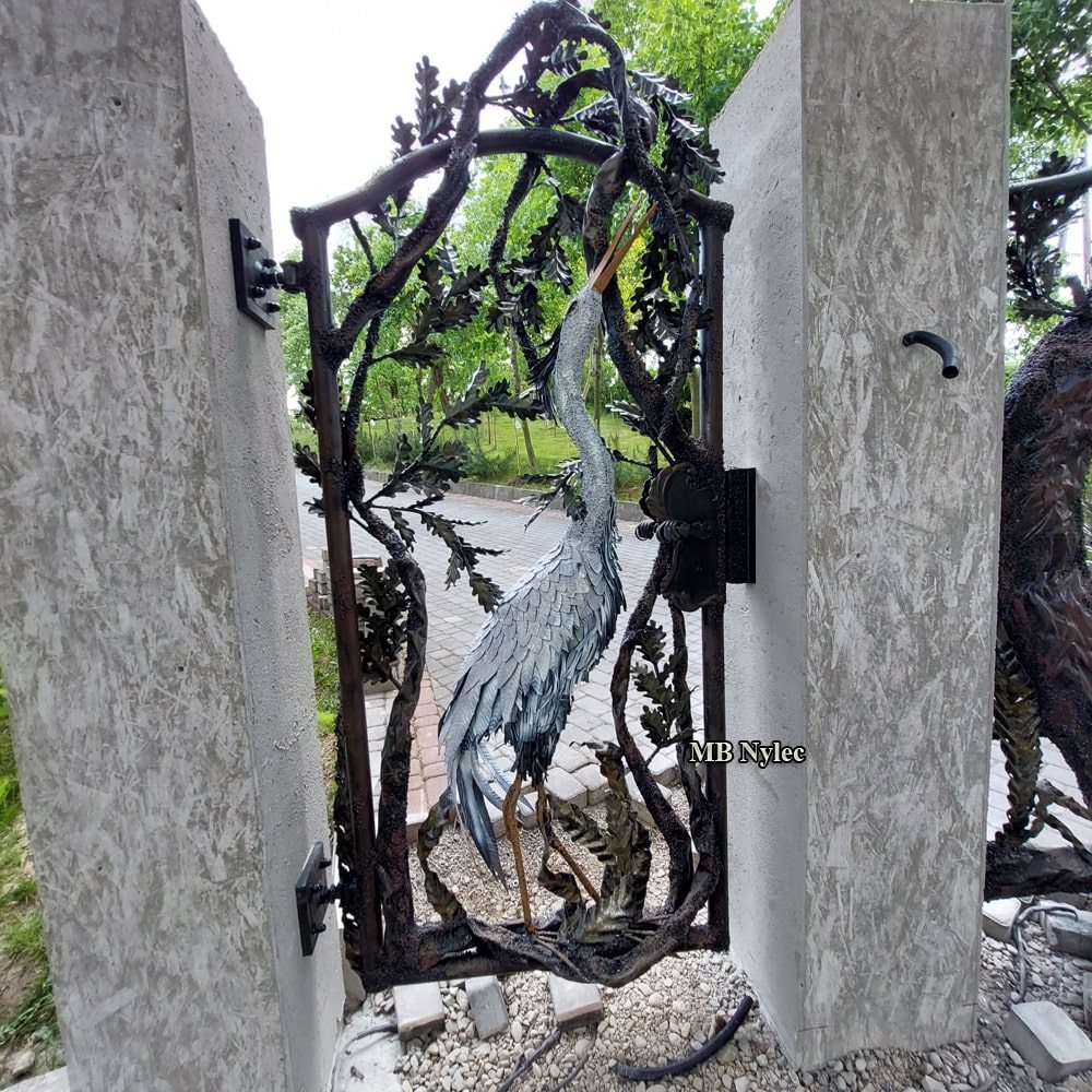 Entrance wicket gate with a heron framed by openwork branches