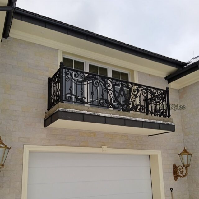 Exterior railing with a crest above the garage of a villa