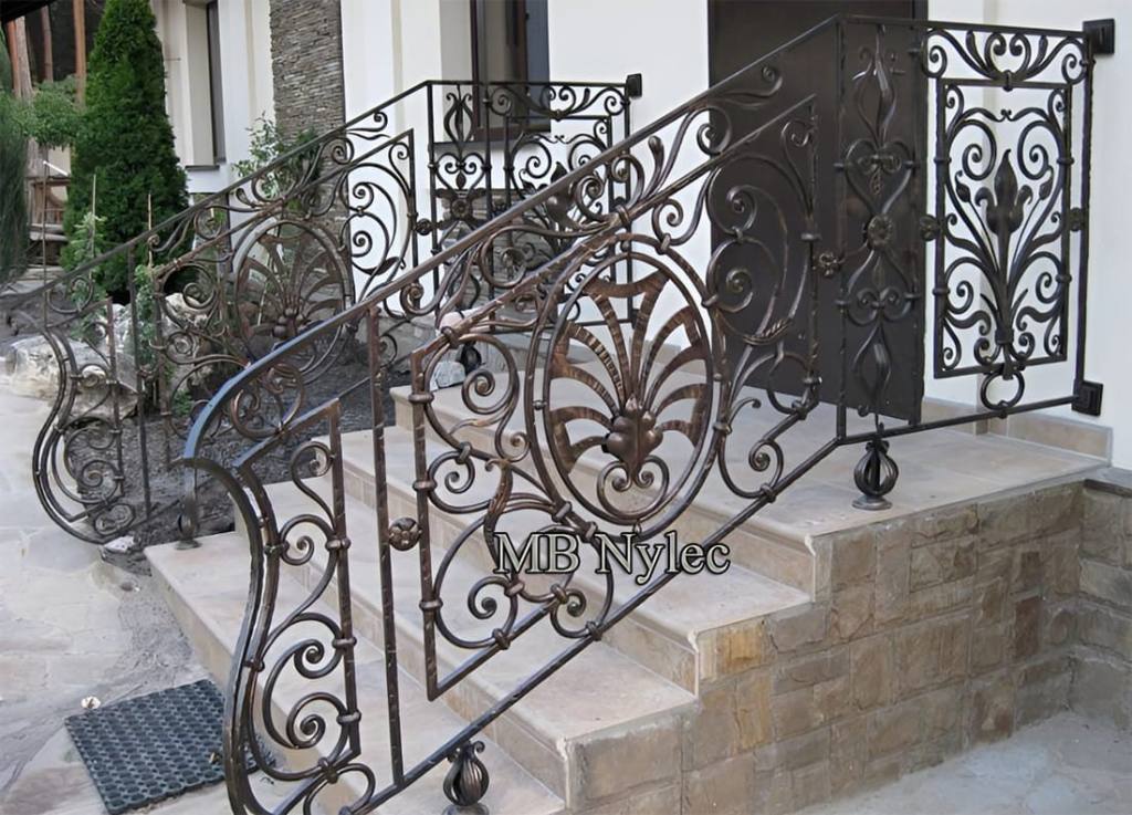 Exterior stair railing BA13 with tall scroll panels and a central fan motif beside entrance steps
