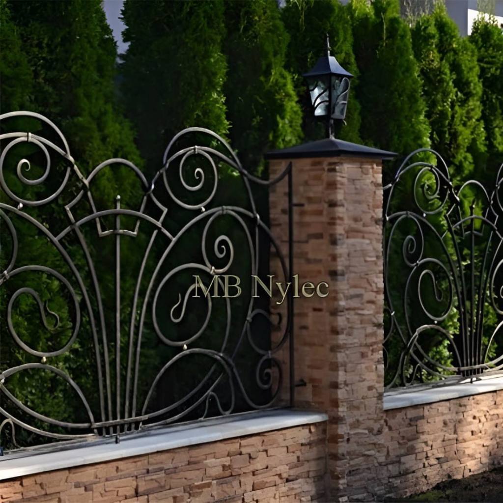 Forged fence BP252 with fan-shaped scrolls in front of thuja trees