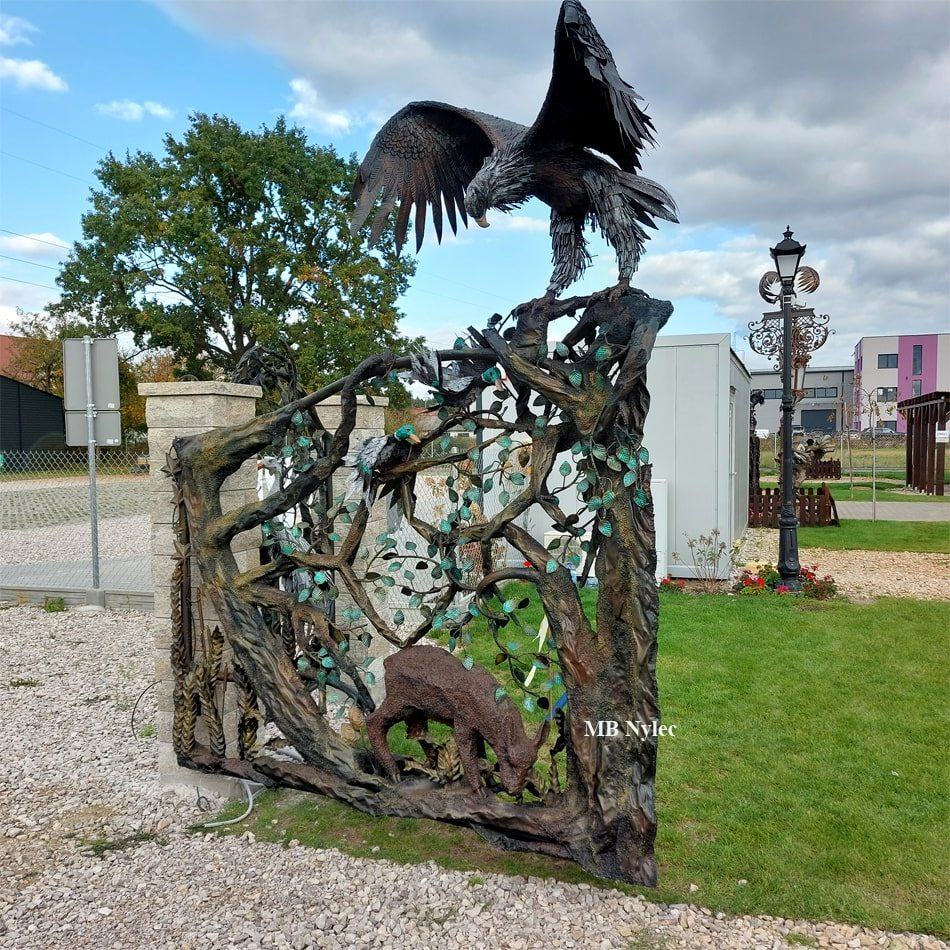 Forged gate with a steel eagle, trunks and roe deer
