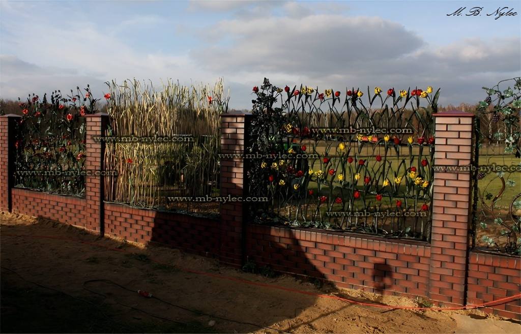 Forged plant fence BM26 with flowers and reeds on a masonry base