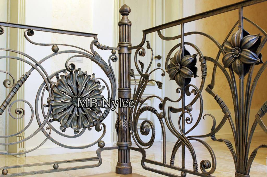 Hand-forged balustrade BA74 with forged lilies, a sunburst rosette and a turned newel post