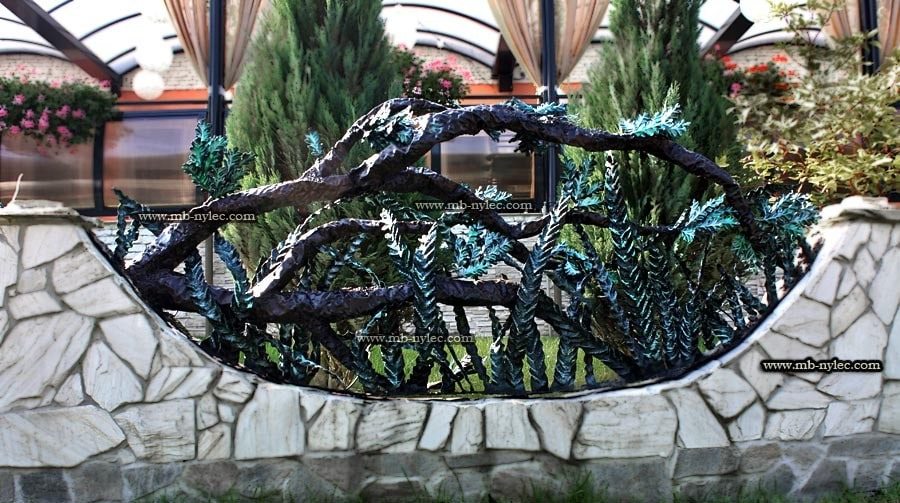 Close view of a forged oak span BM33 on a stone wall