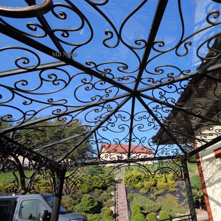 Forged ornament under the glass roof seen from inside the gazebo