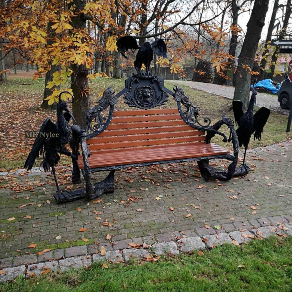 Forged palace bench with a large bird and a lion's head on top