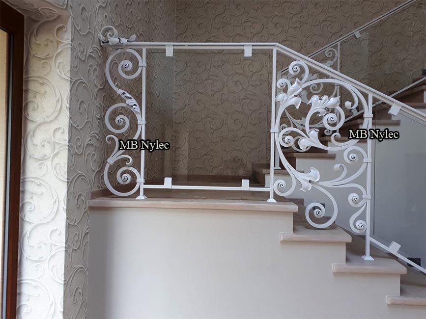 Forged scroll panels with glass along a stair wall, part of balustrade BA68