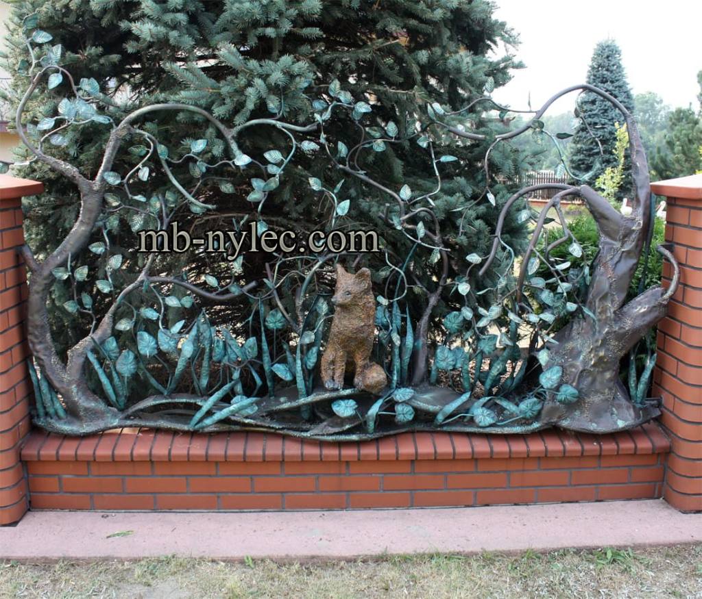 Forged fence span BM21 with a life-size fox sitting among forged trees and undergrowth