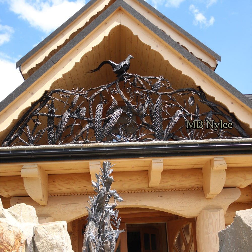 Sculpted gable railing BA85 with a life-size forged pheasant on a timber house