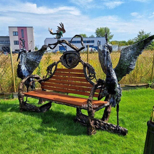 Garden bench with steel herons at Bohema House ecological park