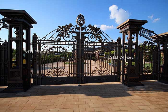 Driveway gate of set BP56 under a forged arch between massive columns
