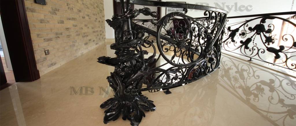 Glamour railing BA5 curving around the landing above a marble floor