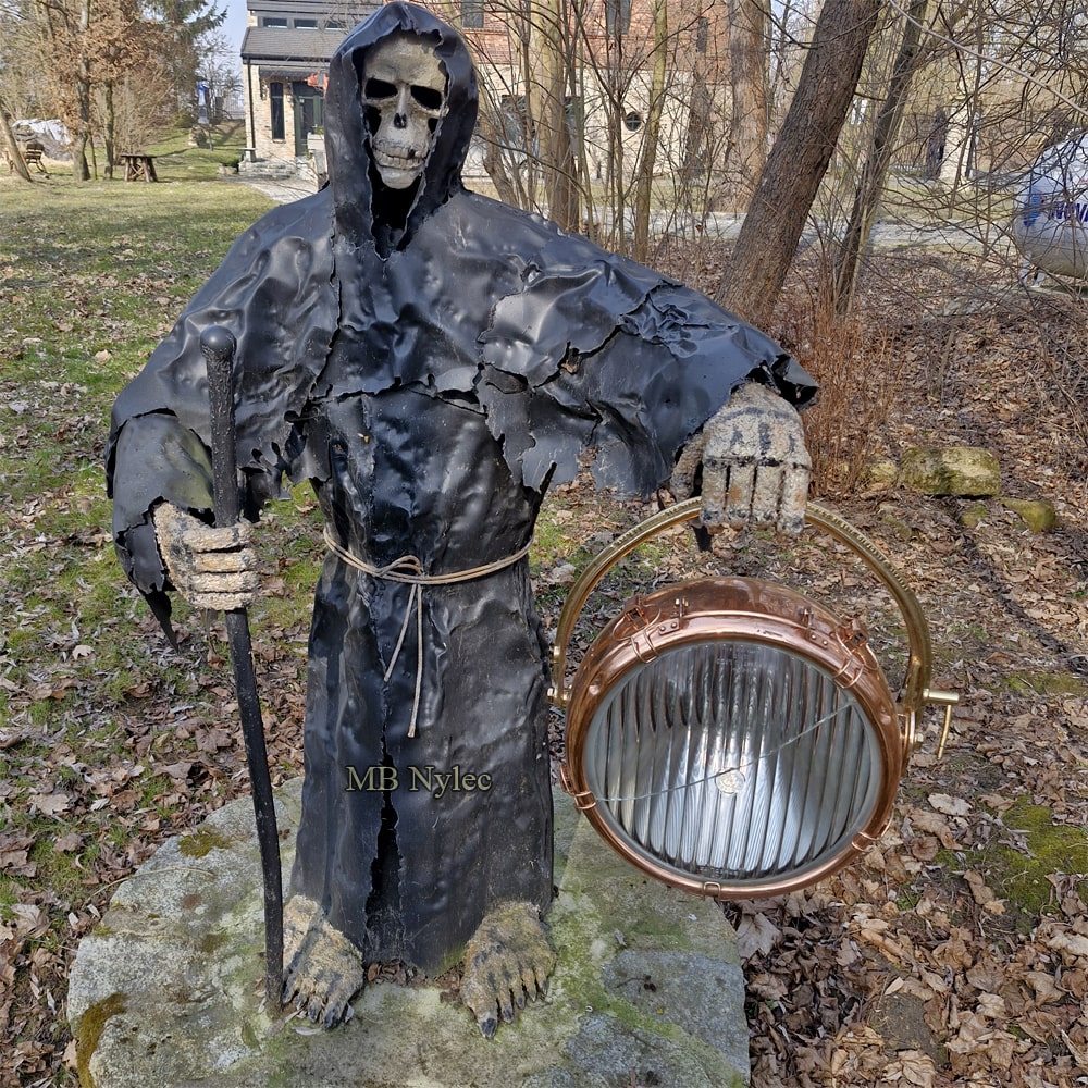Grim Reaper sculpture with a skull under the hood