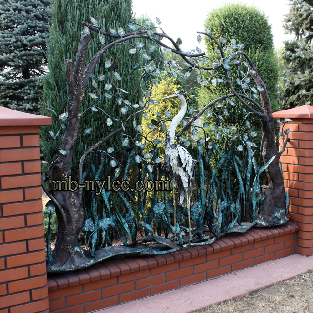 Forged fence span BM18 with a heron among reeds on a brick base