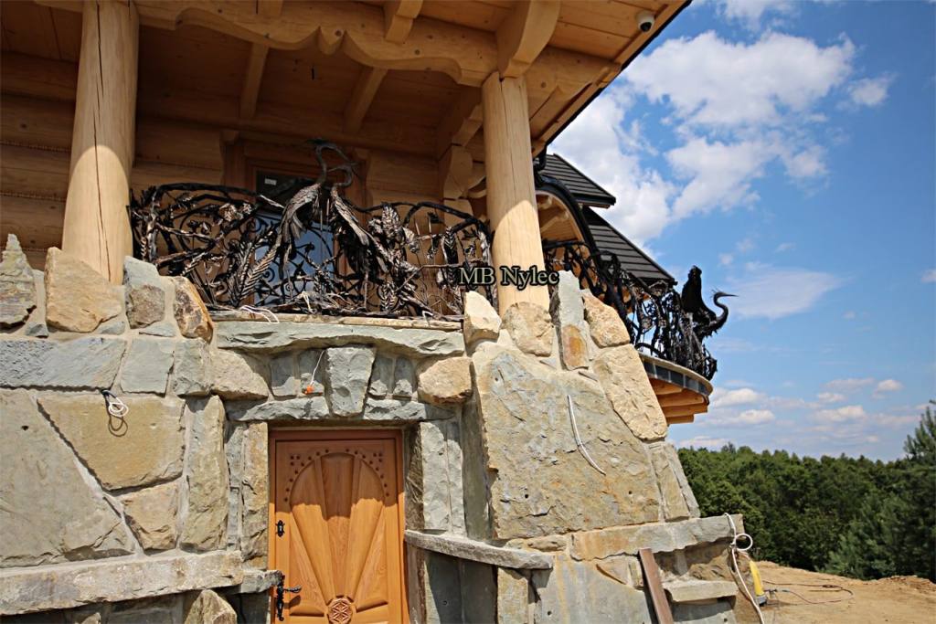 Heron railing BA83 above the arched door of a stone house