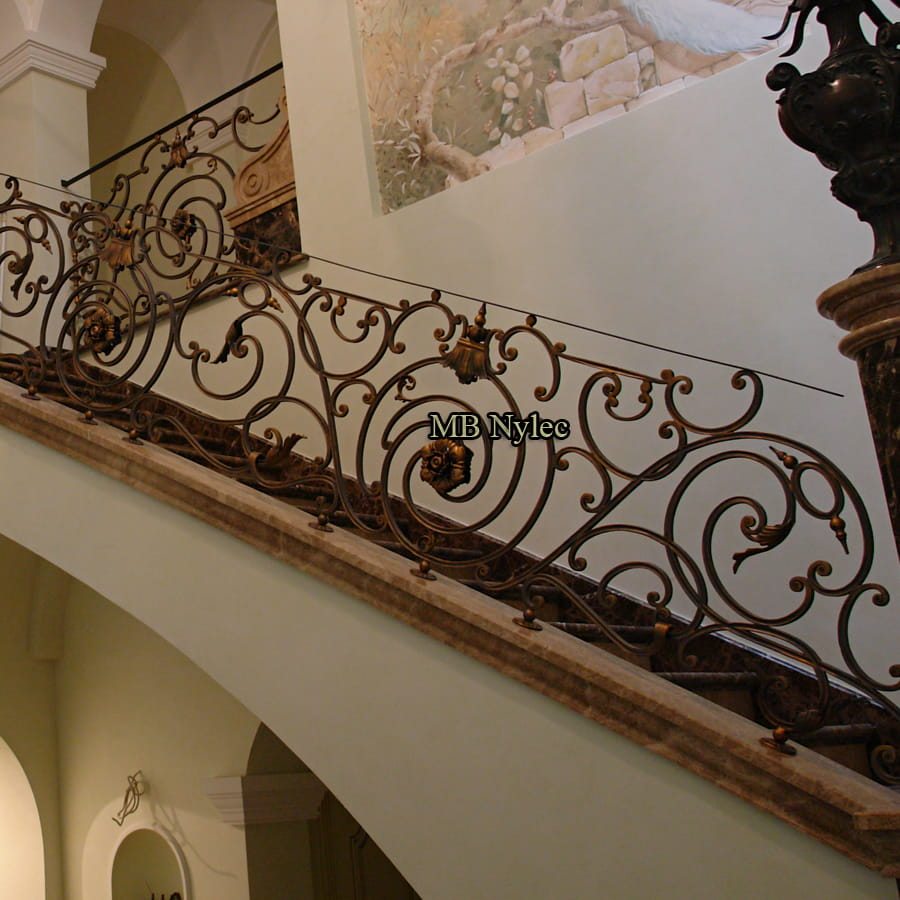 Historic-style forged railing BA20 along an upper gallery with arches and a wooden top rail