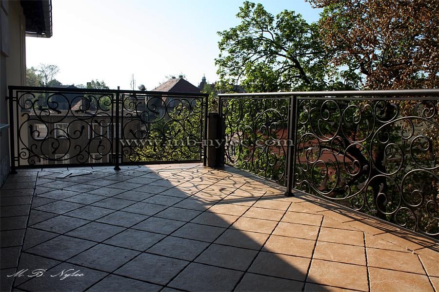 Classic forged terrace railing BA28 with scroll panels on a hotel terrace