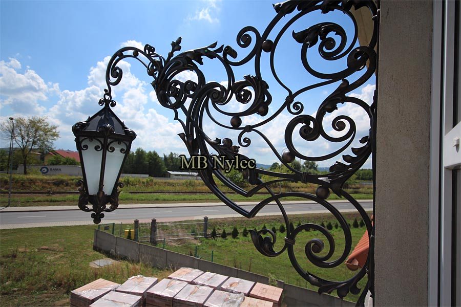Huge forged wall lamp OGD92 with a long openwork bracket and frosted lantern