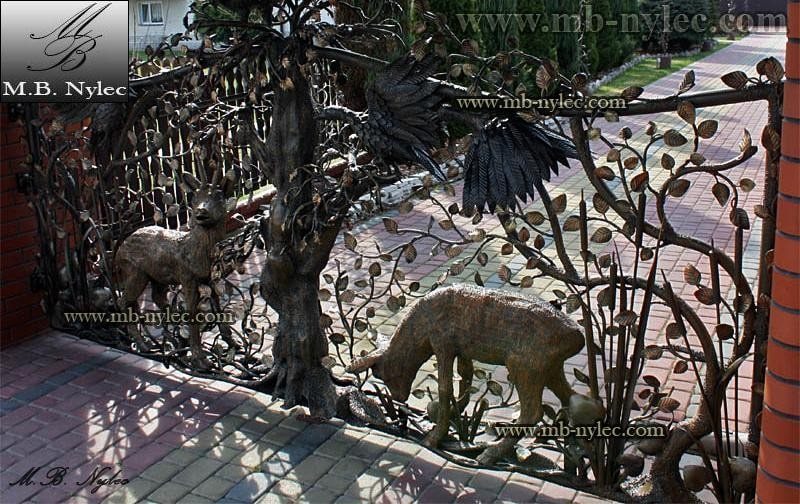 Detail of hunting gate BM1 with a grazing deer and a wolf among forged trees