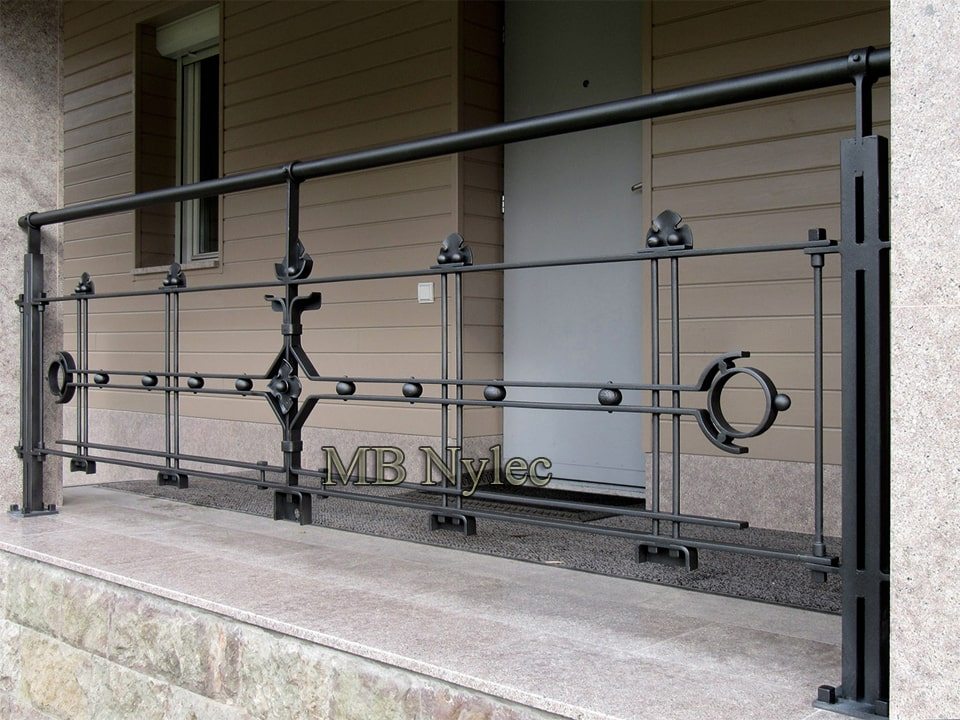 Loft-style outdoor railing BA70 with round posts, horizontal bars and small forged accents beside an entrance