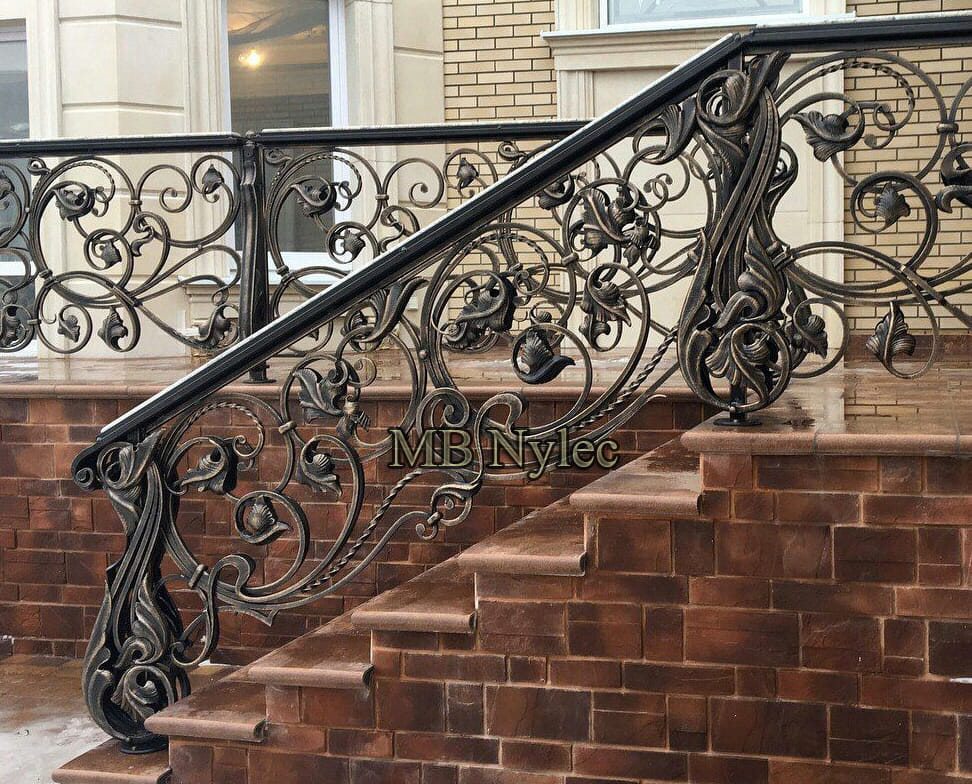 Exclusive exterior stair railing BA58 with flowing scrolls on brick steps