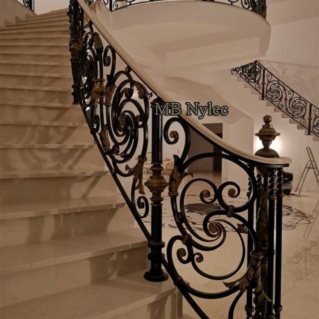 Luxury stair railing with a gold-accented newel post