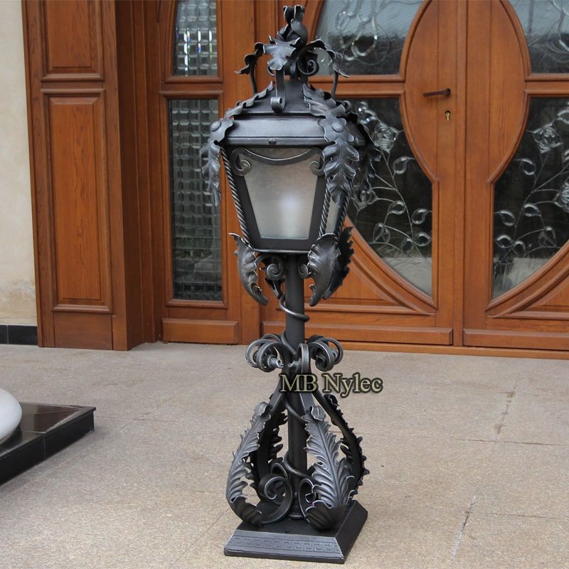 Manor-style forged lamp OGD13 with frosted glass and acanthus leaves by a front door