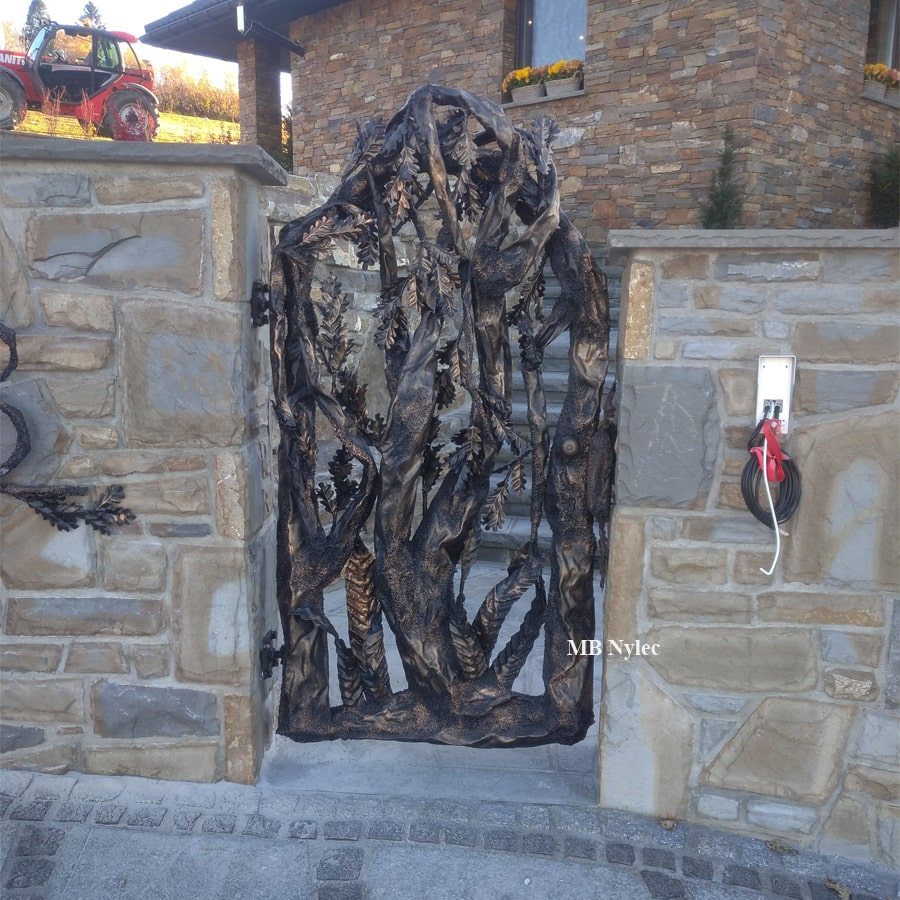 Matching tree-shaped wicket gate in a stone wall