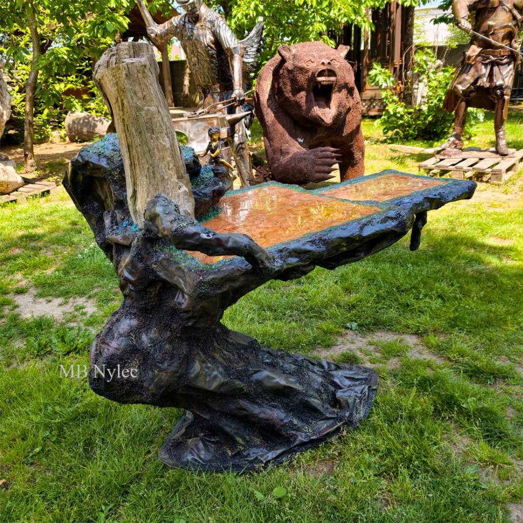 Metal artistic table with a petrified wood trunk base