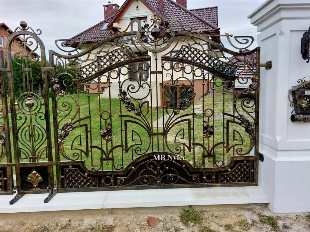 Metal fence arched section with a house behind