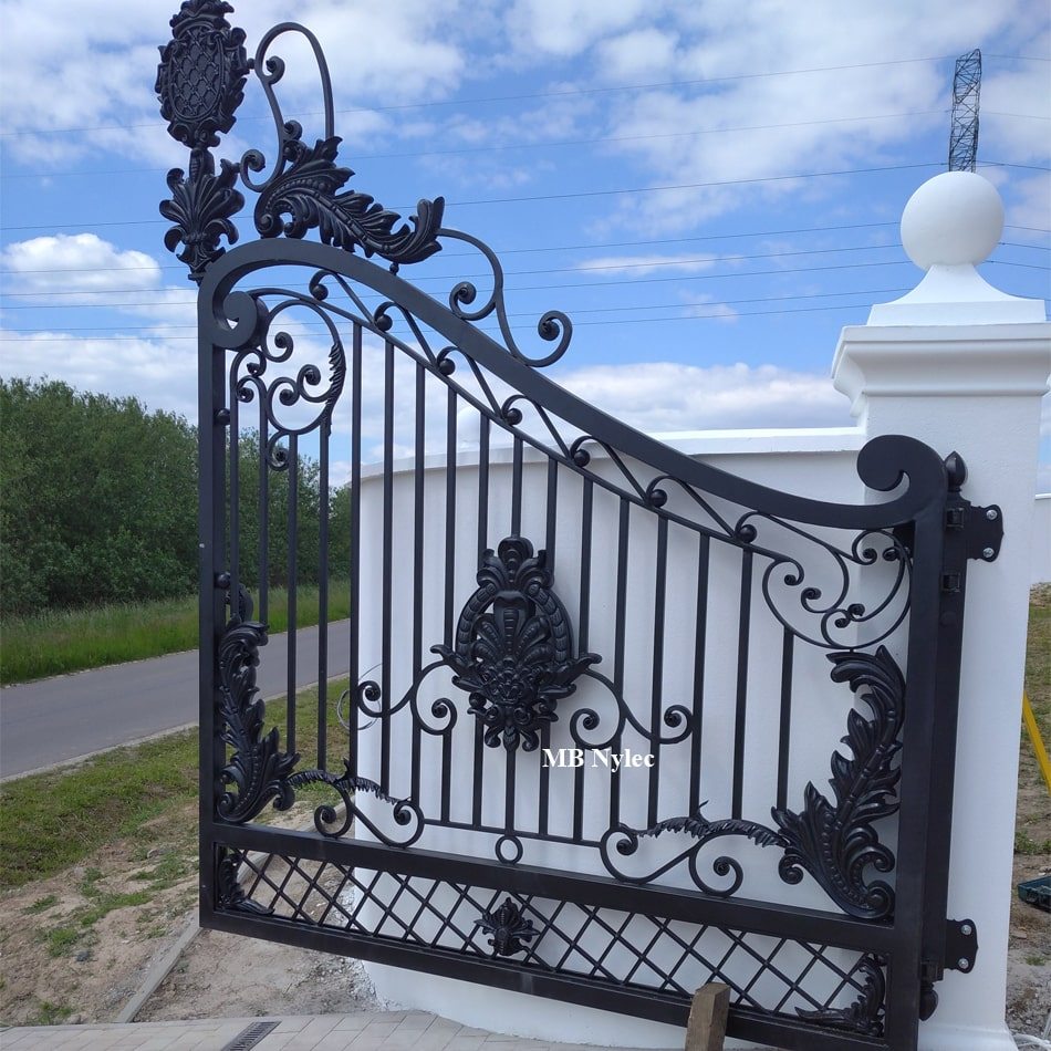 Metal property gate with an arched crest and lattice base