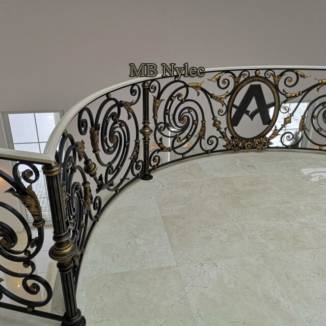 Metal stair railing with an ornate newel post