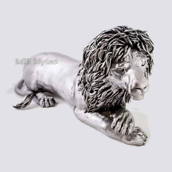 Miniature steel lion lying with paws forward and a mane of forged curls