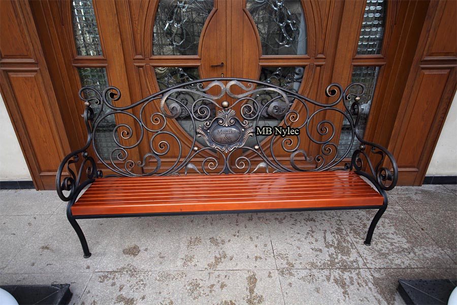 Bench MK1B with a monogram medallion standing on a porch