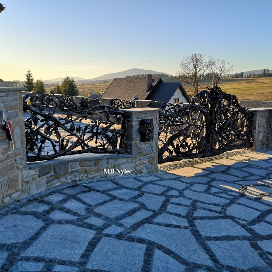 Driveway gate forged as an oak tree with mountains in the background